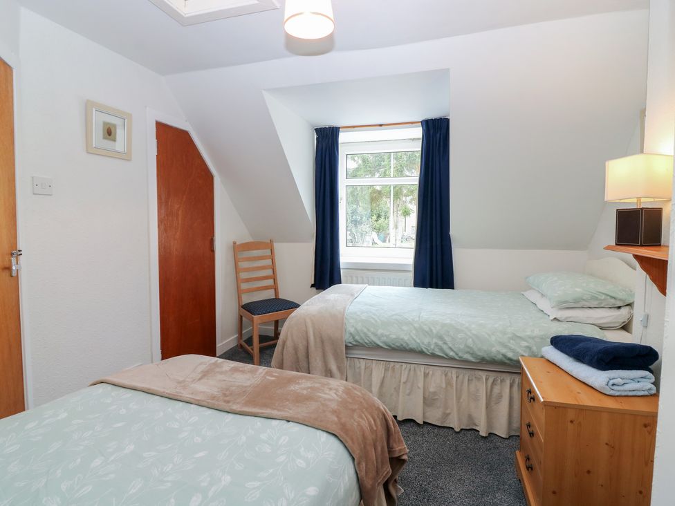 A bedroom with two beds and a window at Alt na Voir in Tomintoul