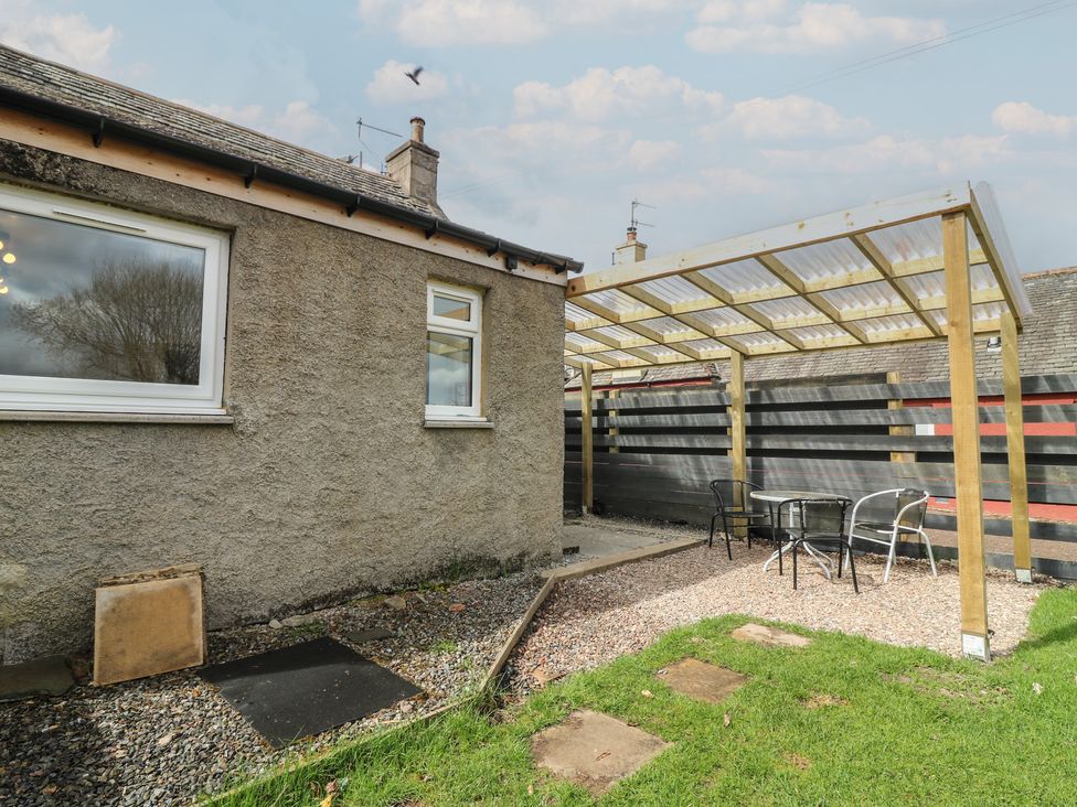 A garden area with a patio and table at Alt na Voir in Tomintoul