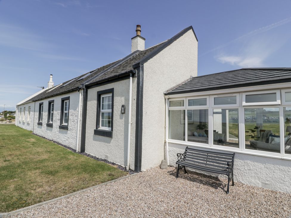 An outdoor area with a bench and house at Ailsa Shores in Turnberry