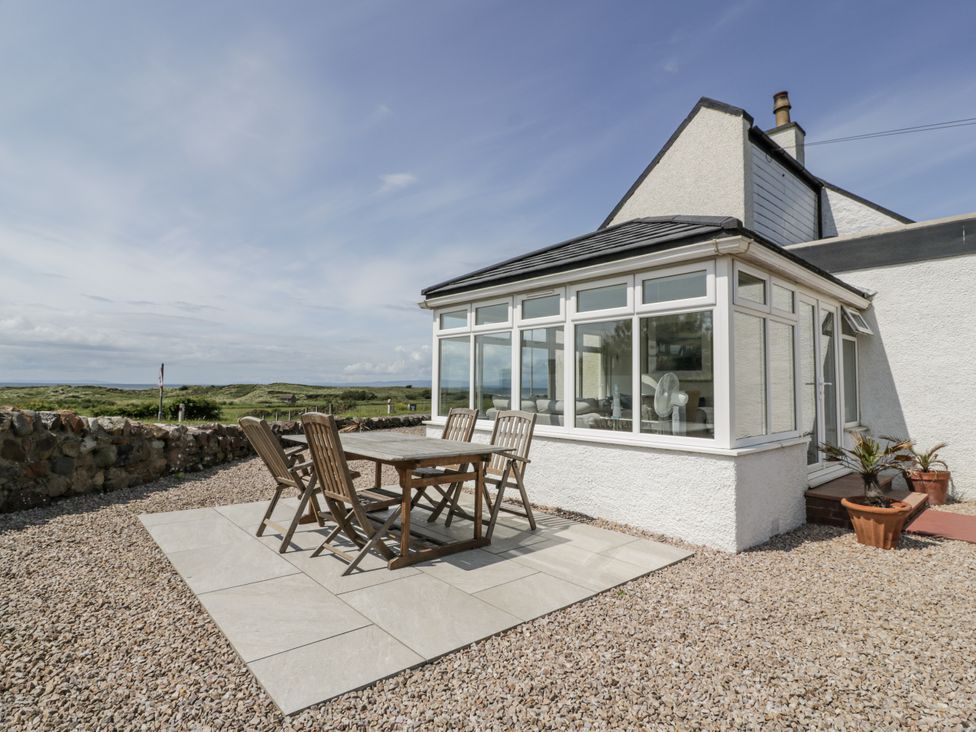 A conservatory with a table and chairs at Ailsa Shores in Turnberry