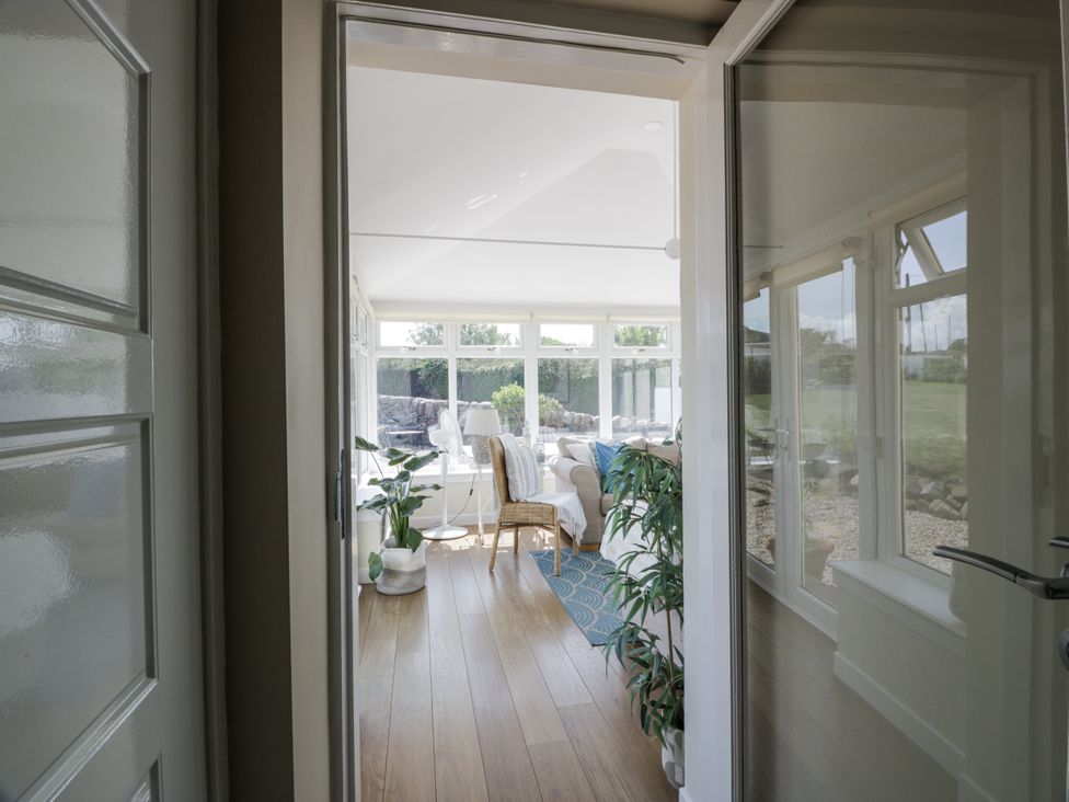 A sunroom visible through a door at Ailsa Shores in Turnberry