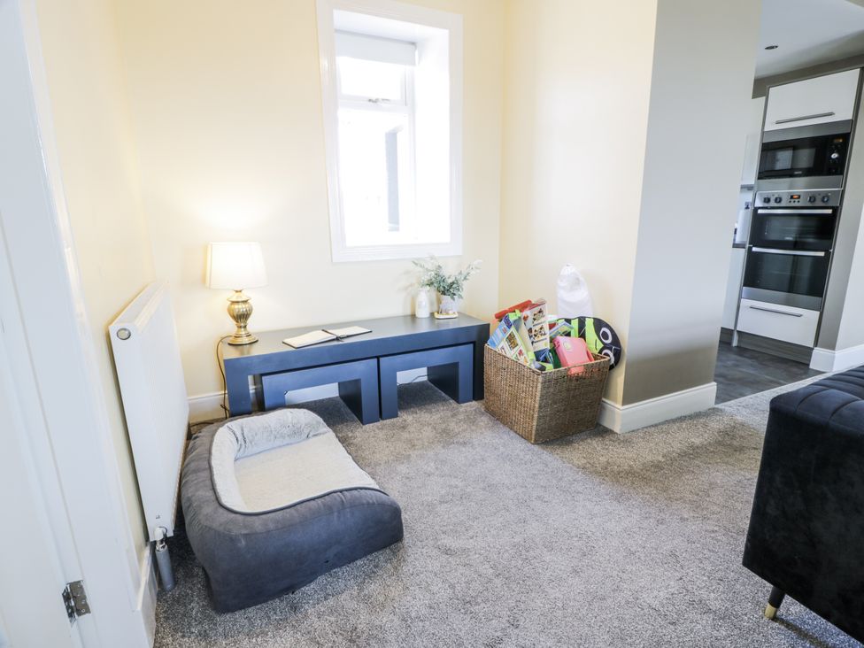 A snug with a table and lamp near a window at Ailsa Shores in Turnberry