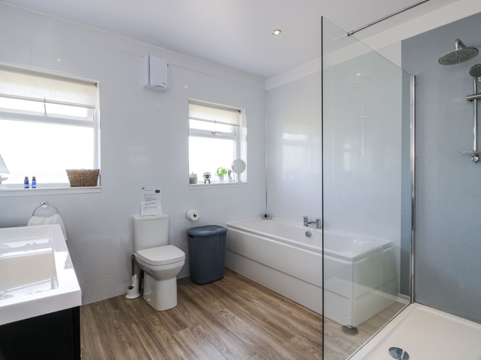 A bathroom with a bathtub, toilet, and shower at Ailsa Shores in Turnberry