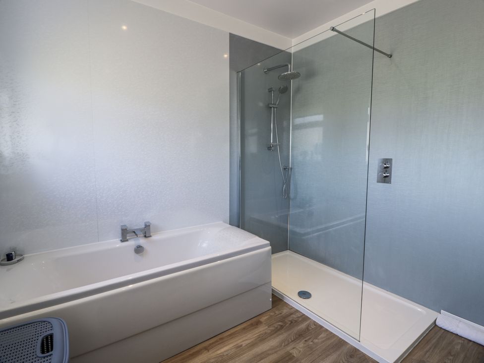 A bathroom with a bathtub and shower at Ailsa Shores in Turnberry