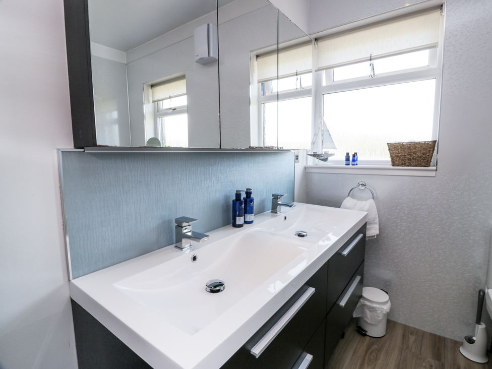 A bathroom with a double sink and mirror at Ailsa Shores in Turnberry