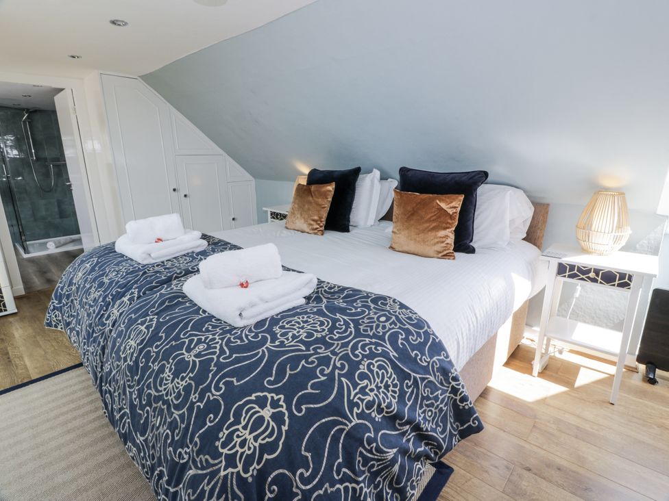 A bedroom with a bed and towel setup at Ailsa Shores in Turnberry