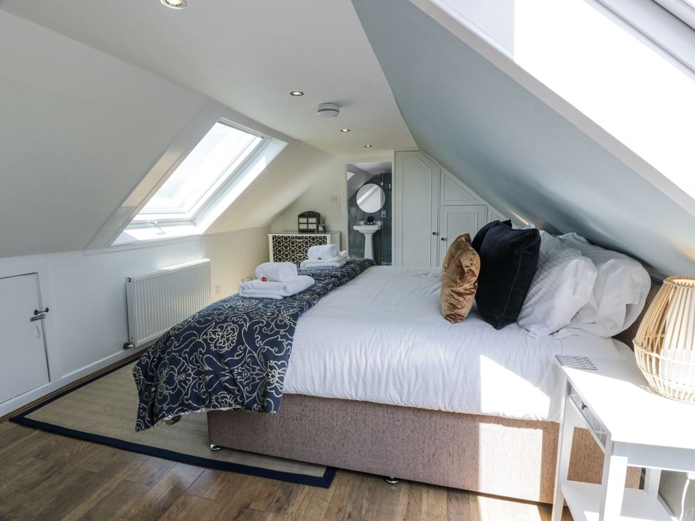 A bedroom with a bed and towels at Ailsa Shores in Turnberry