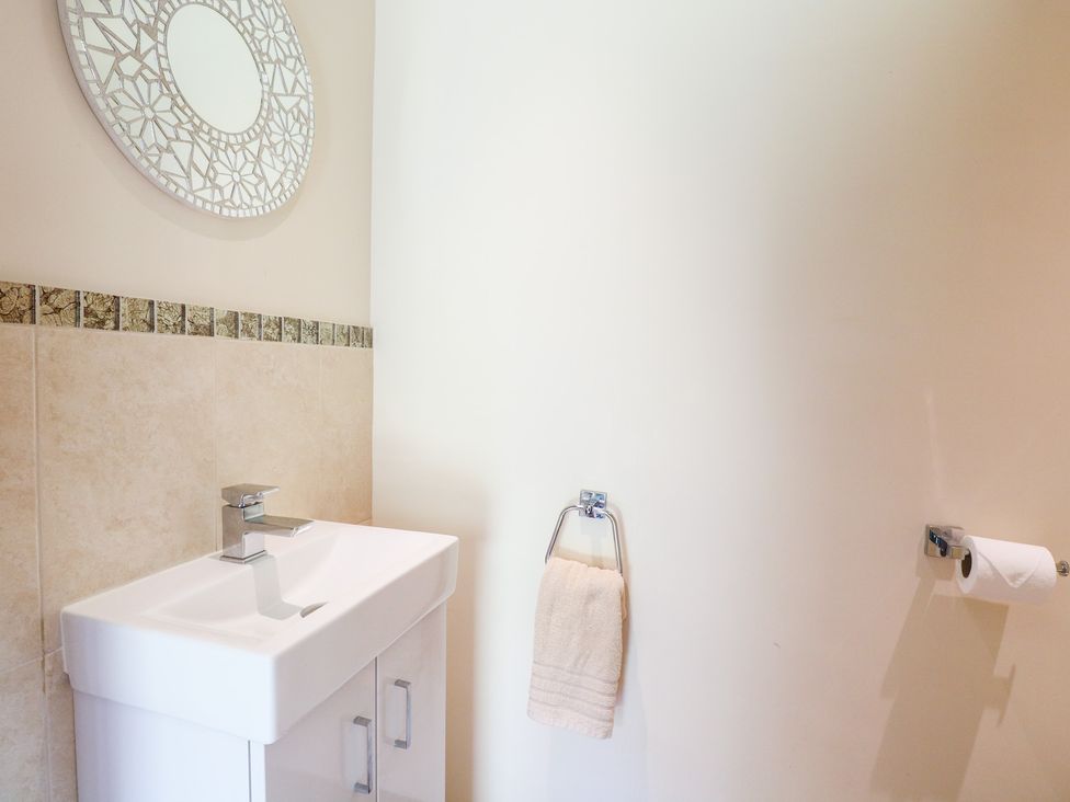 A bathroom with a sink and mirror at The Annexe in Litcham
