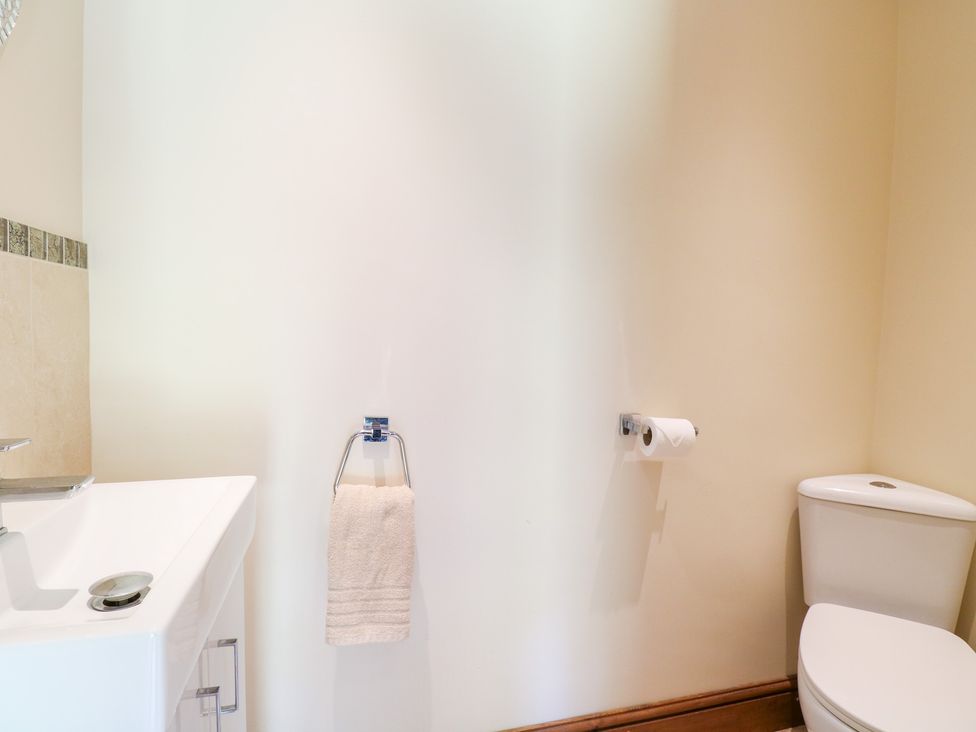 A bathroom with a sink and toilet at The Annexe in Litcham