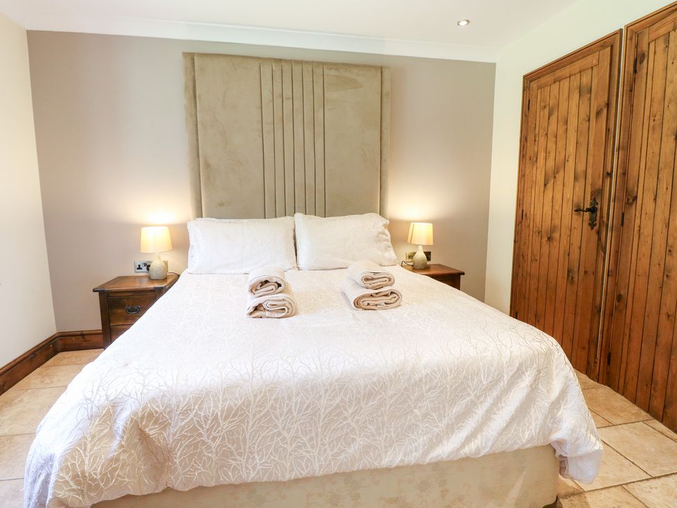 A bedroom with a bed and bedside tables at The Annexe in Litcham