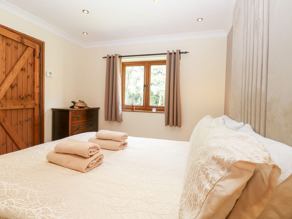 A bedroom with a bed and towels on it at The Annexe in Litcham