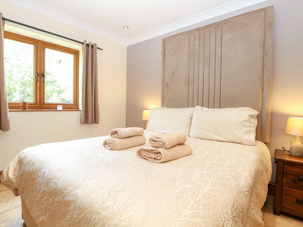 A bedroom with a bed and towels on it at The Annexe in Litcham