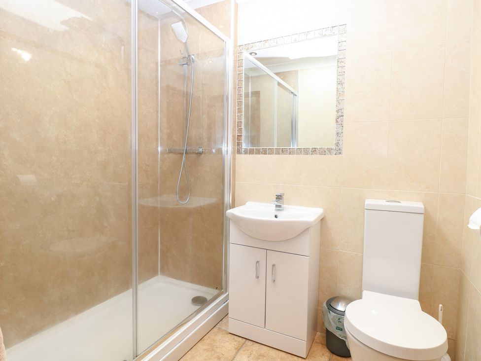 A bathroom with a shower, sink, and toilet at The Annexe in Litcham
