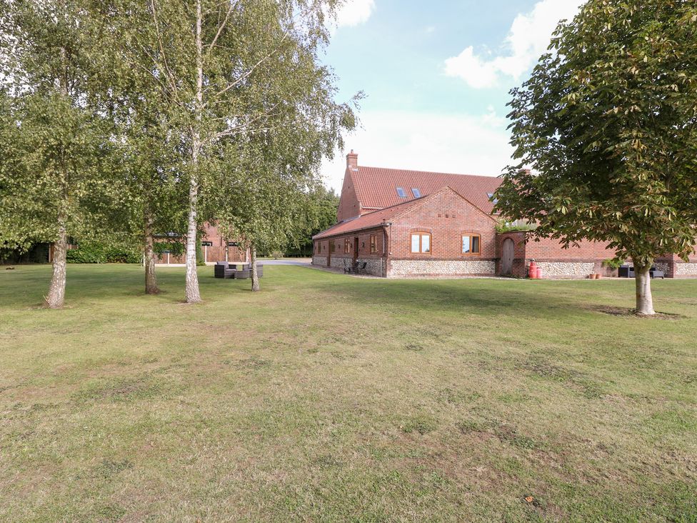 A house with trees and grass at The Annexe in Litcham