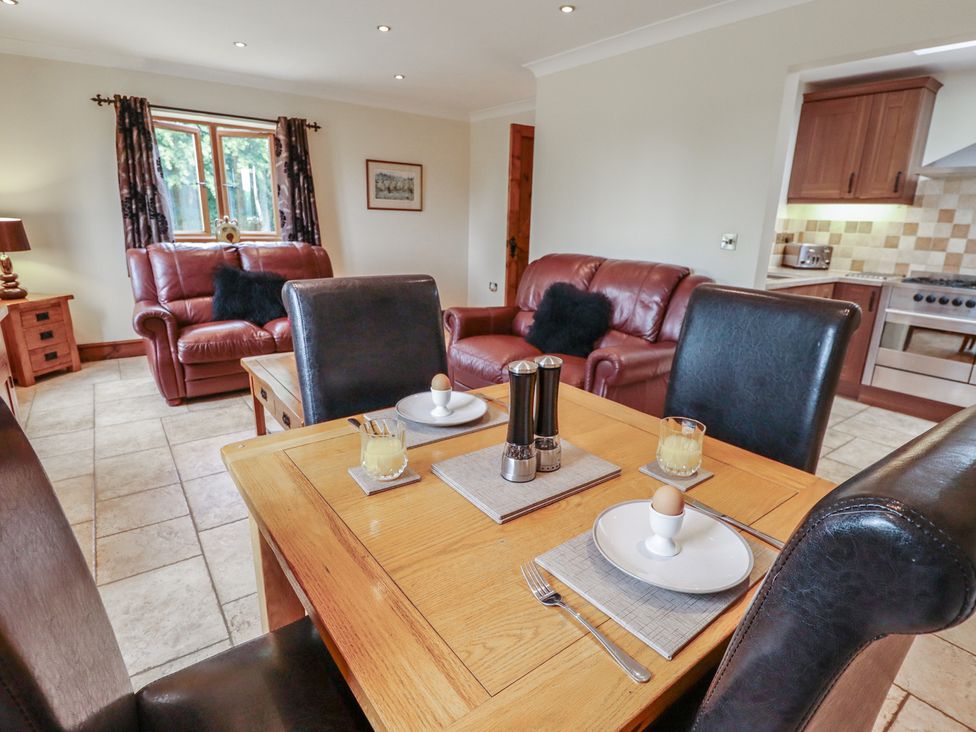 A dining room with a table and chairs at The Annexe in Litcham