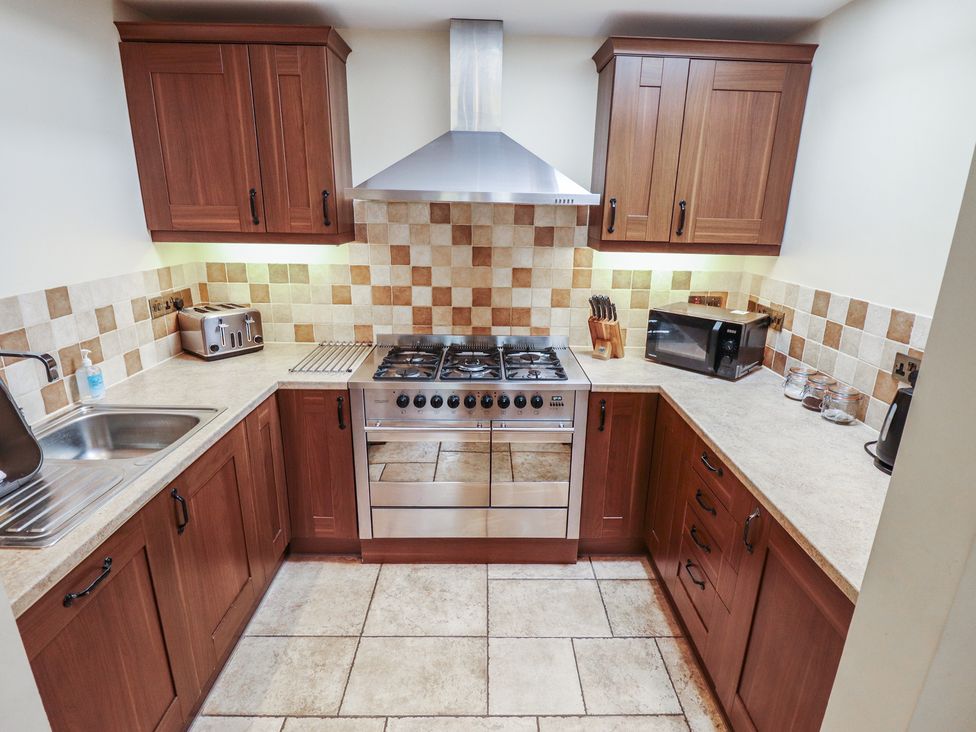A kitchen featuring cabinets and appliances at The Annexe Litcham