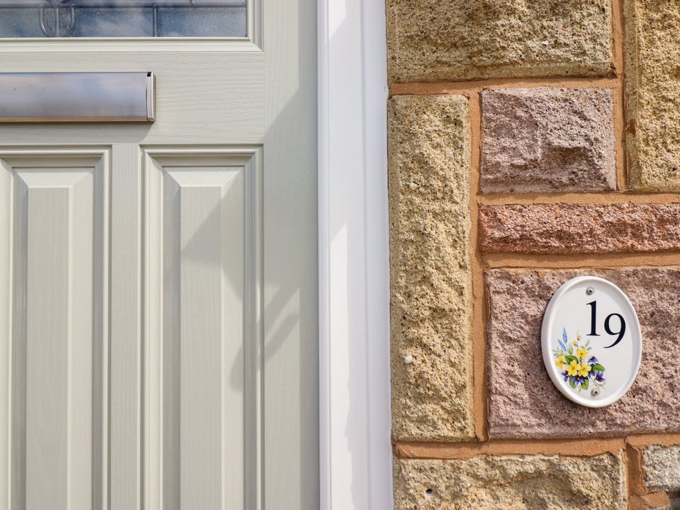 A door with a house number plaque at Chy Bean in Abergele