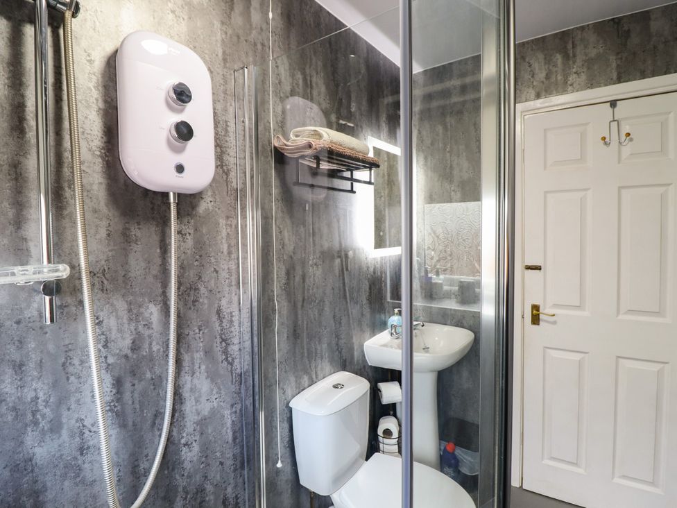 A bathroom with a shower, sink and toilet at Chy Bean Abergele