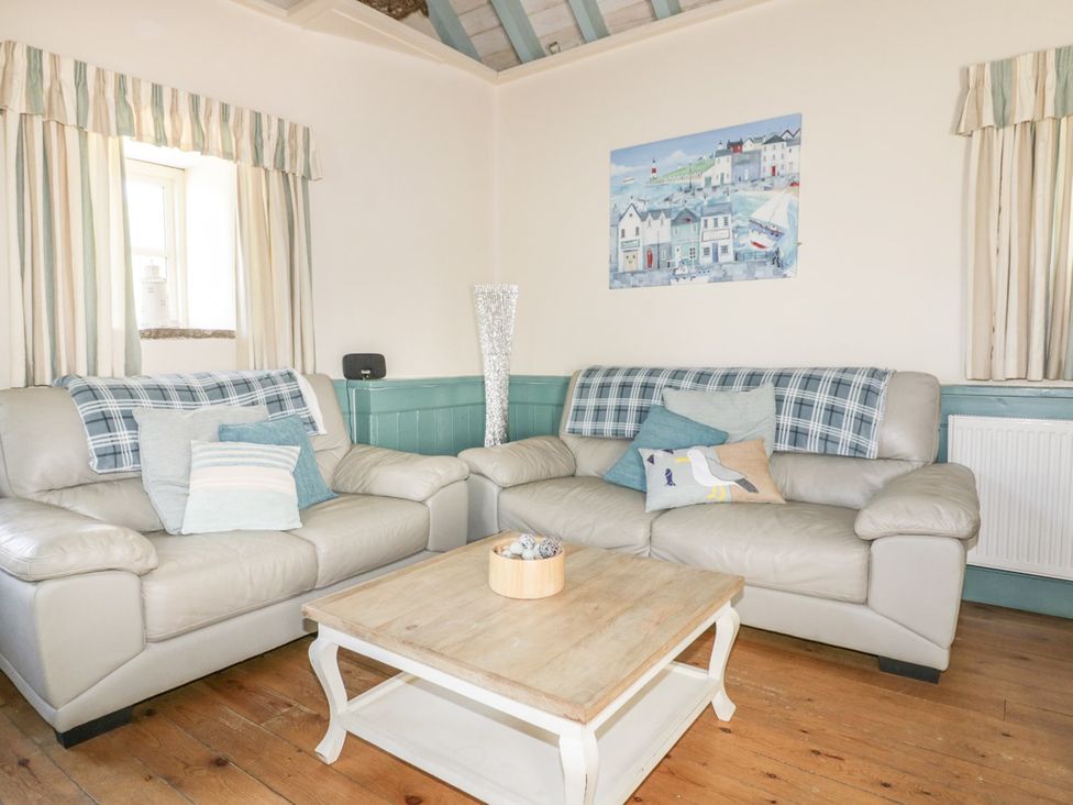 A living room with sofas and a coffee table at Dovecote in Gorran Haven