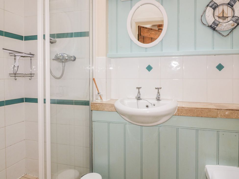 A bathroom with a shower and sink at Dovecote in Gorran Haven