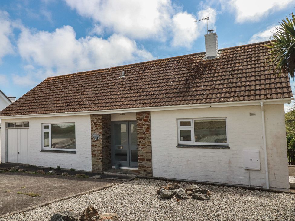 A house with a stone and white exterior at Treverrion in Gorran Haven