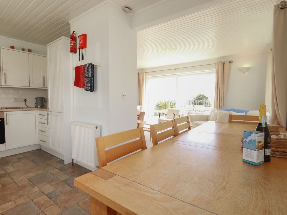 A dining room with a table and chairs at Treverrion in Gorran Haven