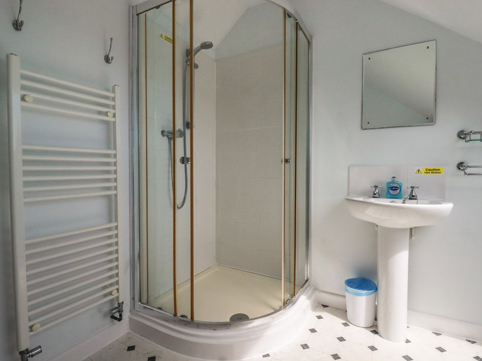 A bathroom with a shower and washbasin at Treverrion in Gorran Haven