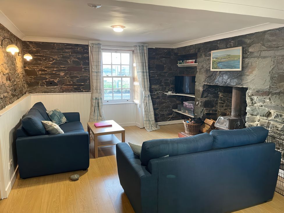 A living room with a sofa and coffee table at The Pink House Isle Of Whithorn