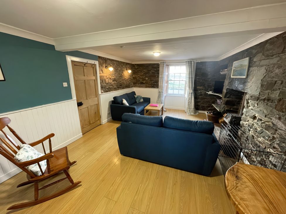 A living room with a sofa and coffee table at The Pink House Isle Of Whithorn