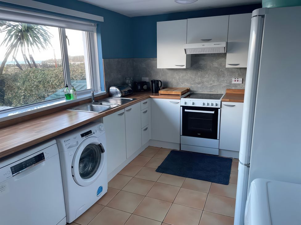 A kitchen with appliances and countertop at The Pink House in Isle Of Whithorn
