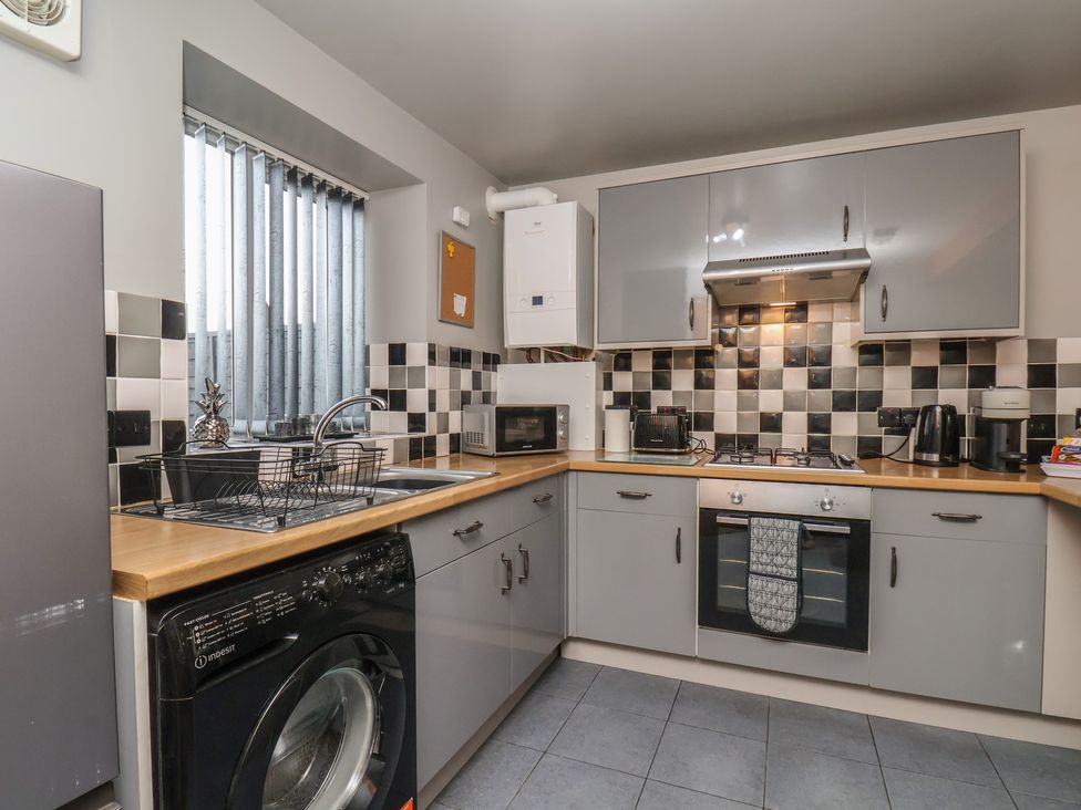 A kitchen with appliances and cabinetry at Fortunatus in Whitby