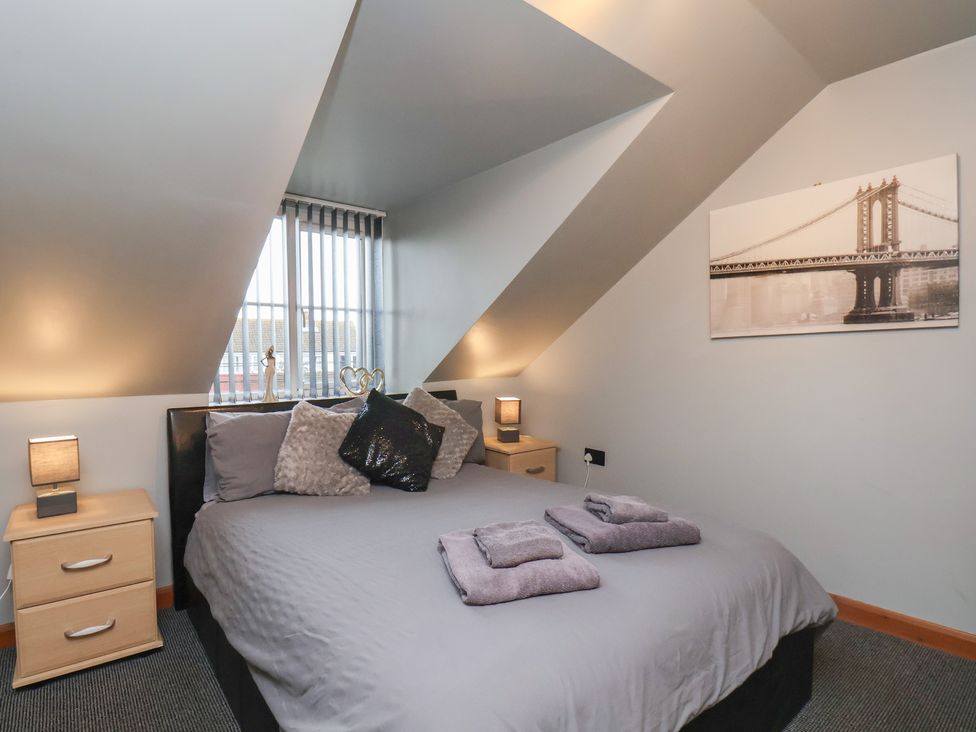 A bedroom with a bed and pillows at Fortunatus in Whitby