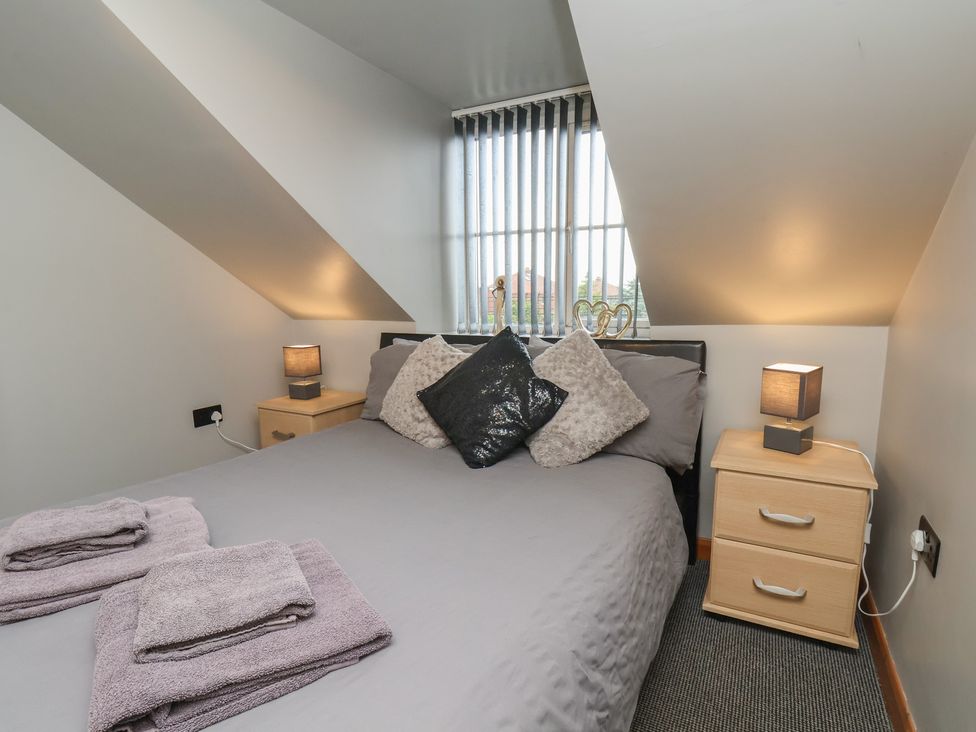 A bedroom with a bed and lamps at Fortunatus in Whitby