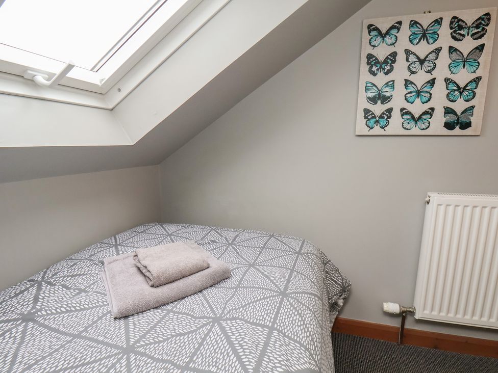 A bedroom with a bed and artwork at Fortunatus in Whitby