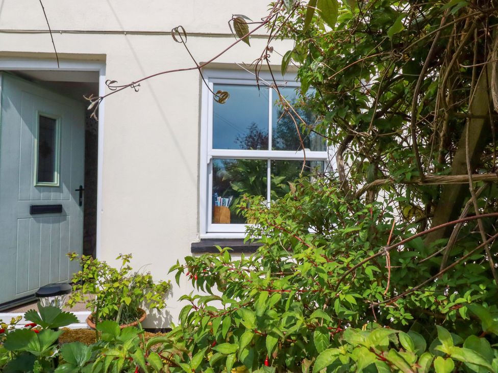 An outdoor area with a window and door at Longview Cottage, Penwithick neat St Austell
