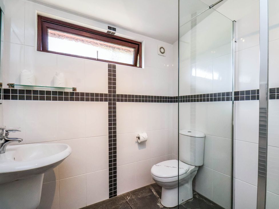A bathroom with a sink, toilet and shower at Snowdrop in Saltburn-by-the-Sea