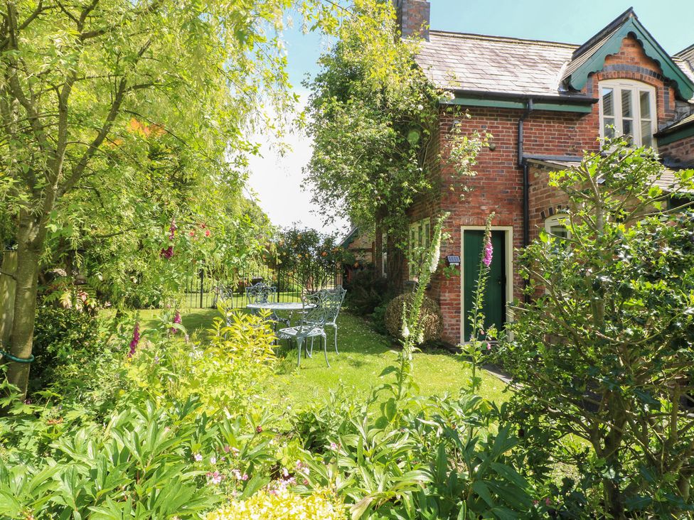 A garden with seating and greenery at Just A Cottage, Newlands Farm in Golden Valley near Riddings and Alfreton