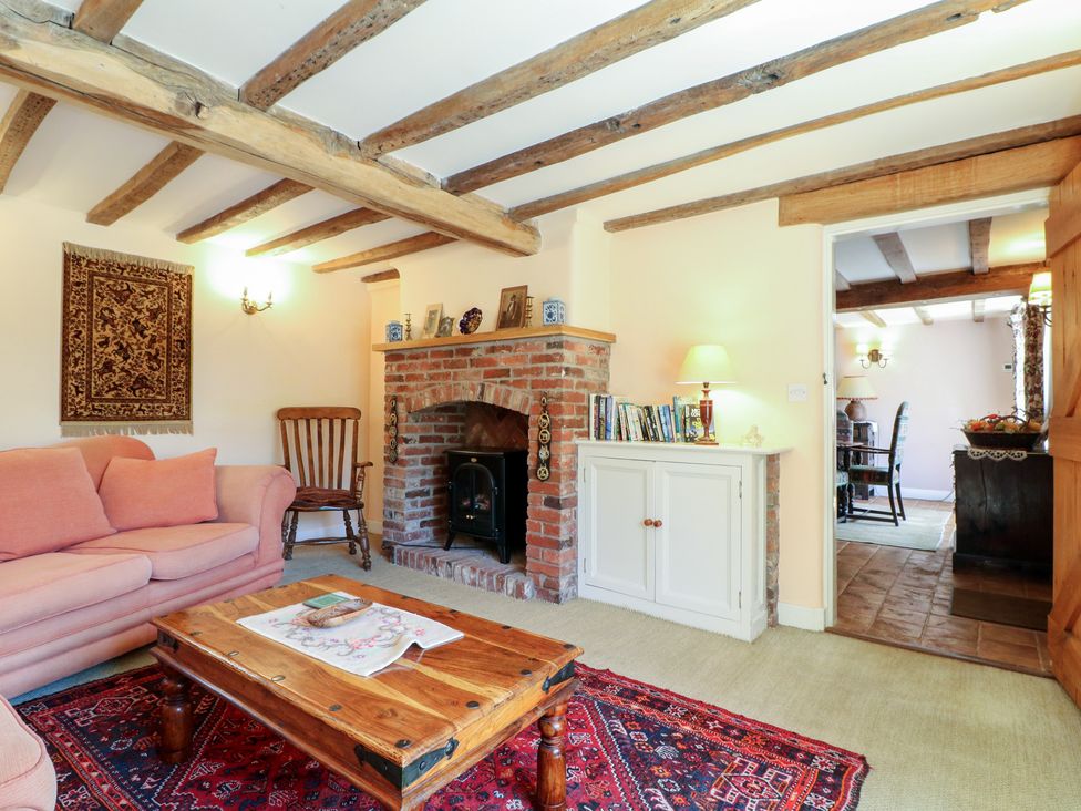 A living room with a sofa and coffee table at Just A Cottage, Newlands Farm in Golden Valley near Riddings and Alfreton