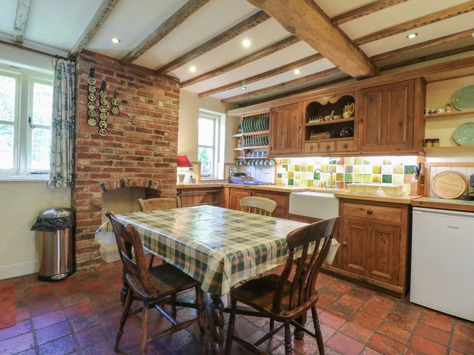 A kitchen with a table and chairs at Just A Cottage, Newlands Farm in Golden Valley near Riddings and Alfreton