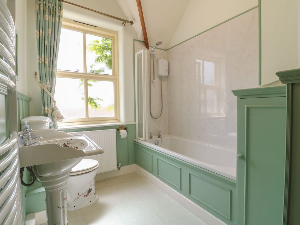 A bathroom featuring a sink, bathtub, and toilet at Just A Cottage, Newlands Farm in Golden Valley near Riddings and Alfreton