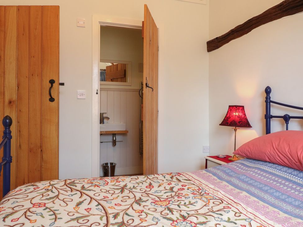A bedroom with a bed and a lamp at Just A Cottage, Newlands Farm Golden Valley near Riddings and Alfreton