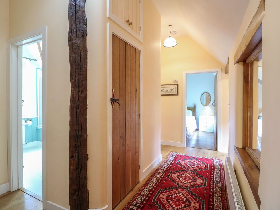 A hallway with doors leading to a bathroom and bedroom at Just A Cottage, Newlands Farm, Golden Valley near Riddings and Alfreton