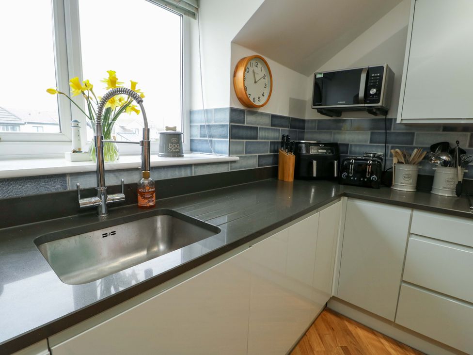 A kitchen with a sink and appliances at Maelog, 14 Tides Reach Rhosneigr