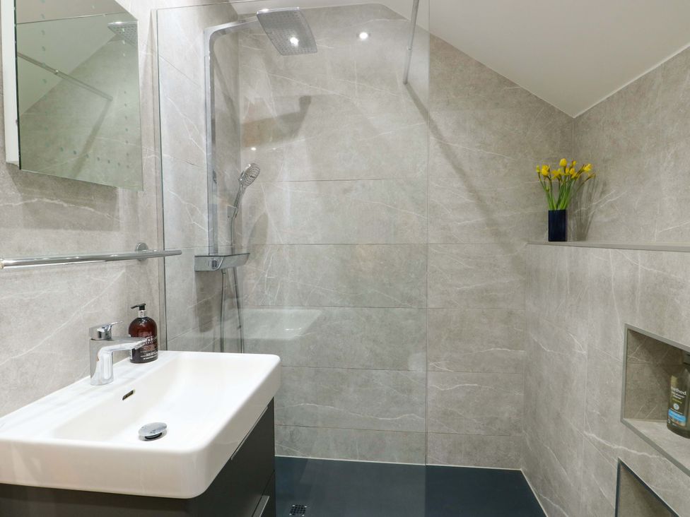 A bathroom with a shower and sink at Maelog, 14 Tides Reach, Rhosneigr