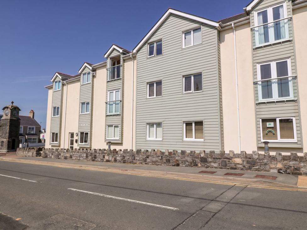 A building with multiple windows and a clock tower at Maelog, 14 Tides Reach, Rhosneigr