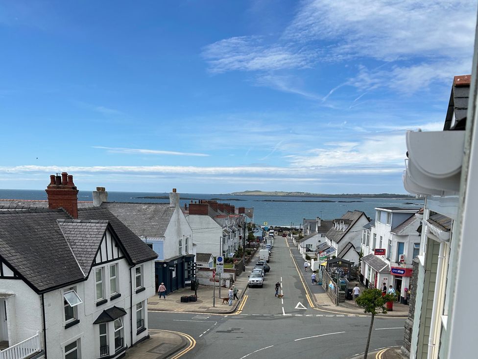 A view of a street and ocean at Maelog, 14 Tides Reach Rhosneigr