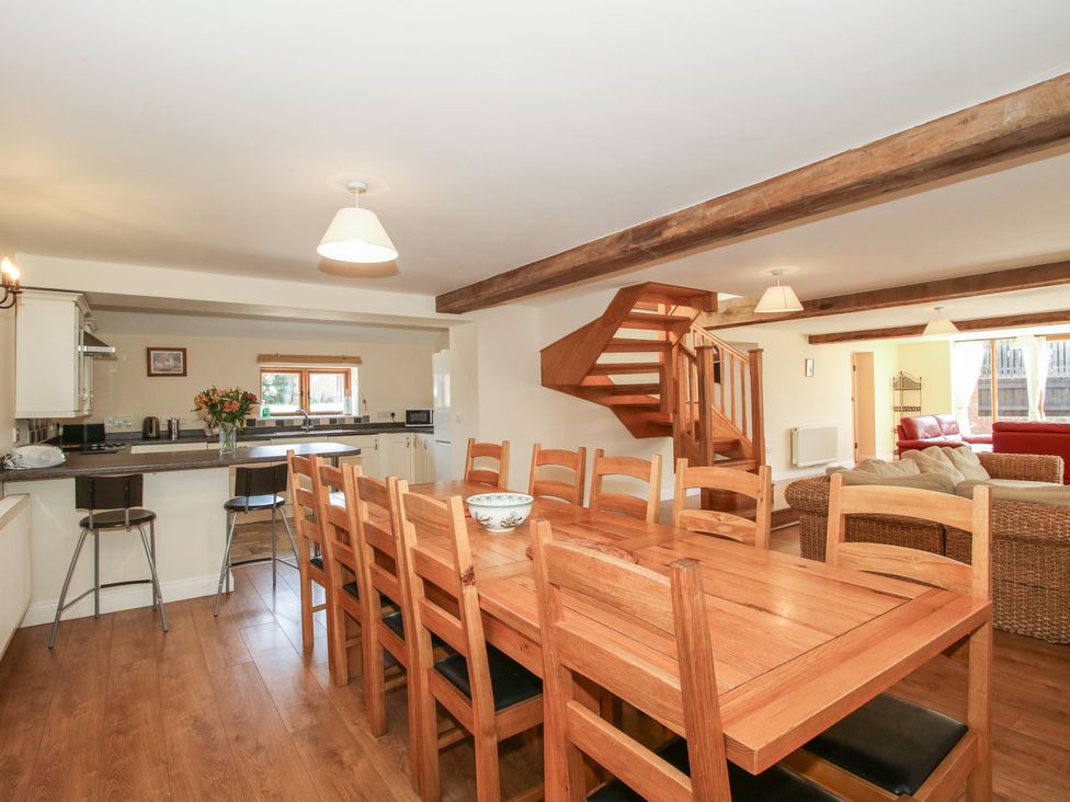 A dining room with a large table and chairs at The Wainhouse in Bockleton near Tenbury Wells