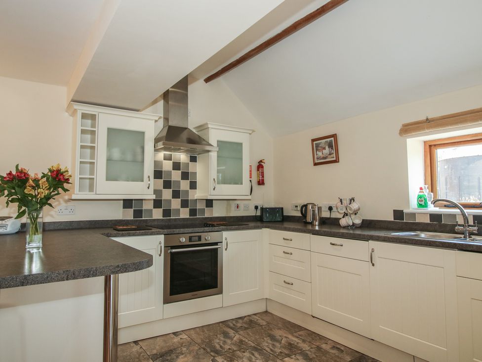 A kitchen with appliances and cabinets at The Wainhouse in Bockleton near Tenbury Wells
