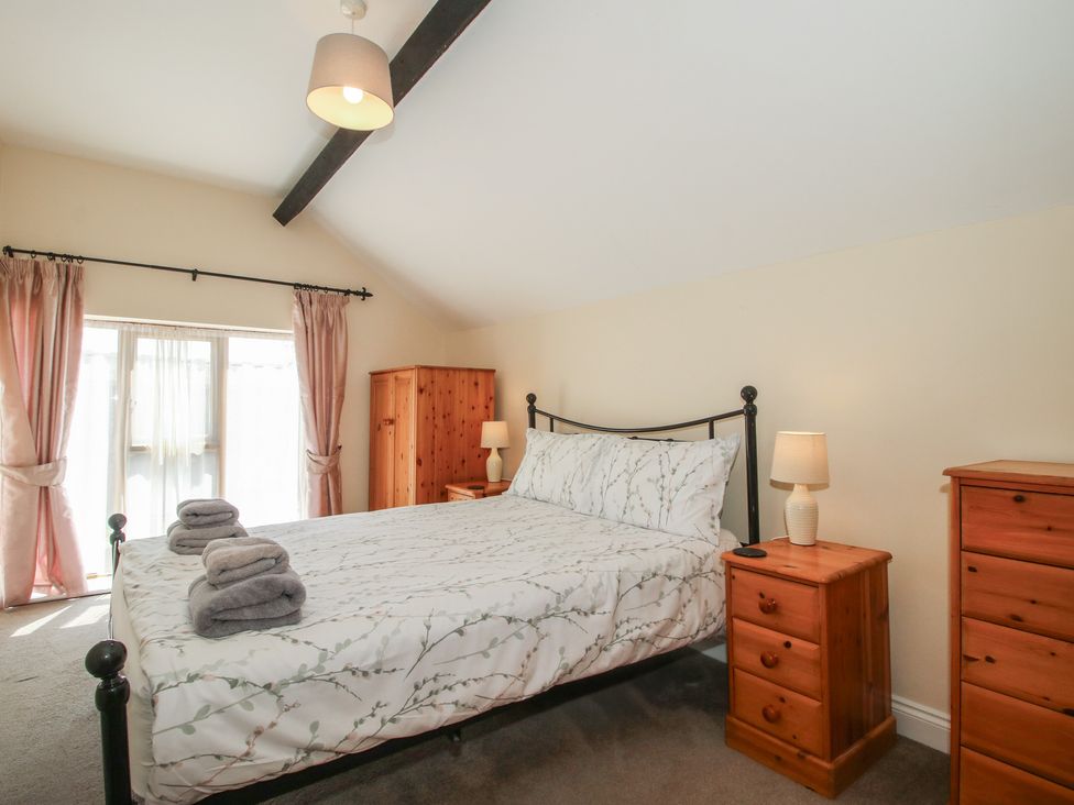 A bedroom with a bed and furniture at The Wainhouse in Bockleton near Tenbury Wells
