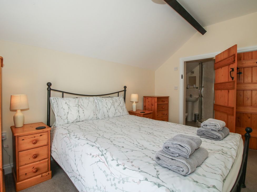 A bedroom with a bed and bedside tables at The Wainhouse in Bockleton near Tenbury Wells